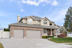 View of front of house with a front yard and a garage