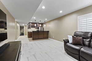 Carpeted living room with wet bar