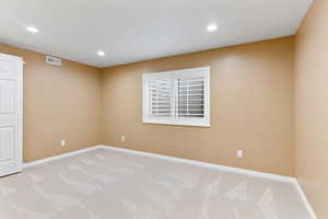 Unfurnished room featuring light colored carpet