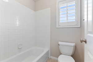 Bathroom featuring toilet and tiled shower / bath