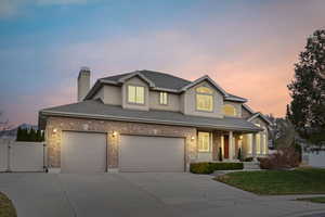 View of front of home featuring a yard and a garage