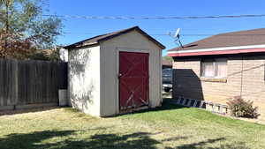 View of outbuilding with a yard