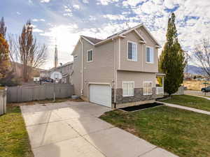 Side entry garage with an expansive driveway, enough room to park an RV.