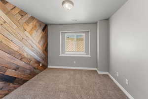 Carpeted empty room featuring a textured ceiling