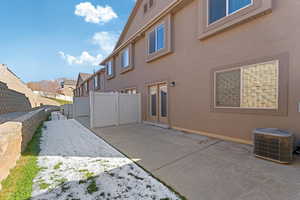 Back of property with a patio and cooling unit