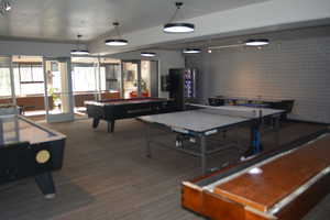 Rec room with shuffle board, ping pong, pool, and air hockey.