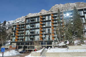 Snow covered building with a mountain view