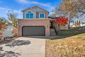 Front facade with a garage and a front lawn