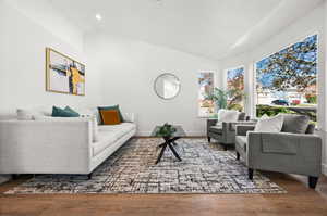 Living room featuring hardwood / wood-style flooring and vaulted ceiling