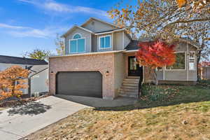 View of front property with a garage and a front lawn