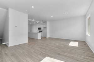 Unfurnished living room featuring light hardwood / wood-style floors