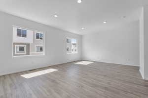 Empty room with light hardwood / wood-style flooring