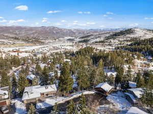 Snowy aerial view featuring a mountain view