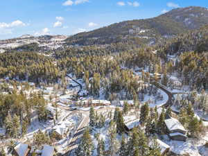 Snowy aerial view featuring a mountain view