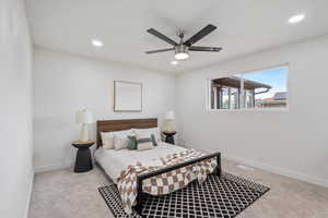 Bedroom featuring light colored carpet and ceiling fan