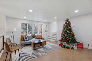 Living room featuring a textured ceiling and light hardwood / wood-style flooring