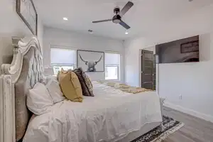 Bedroom with light hardwood / wood-style floors and ceiling fan