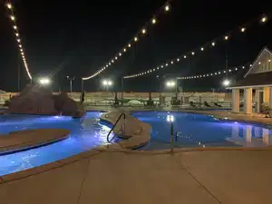 Pool at night with a patio