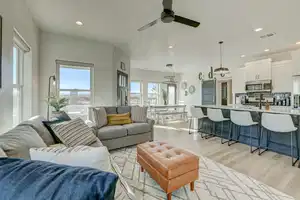 Living room featuring ceiling fan and light hardwood / wood-style flooring