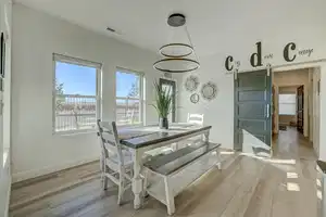 Dining room featuring a barn door and light wood-type flooring