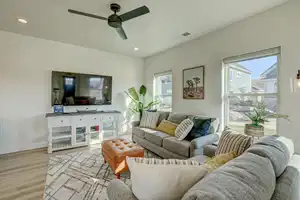 Living room featuring ceiling fan and light wood-type flooring