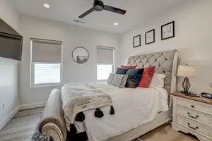 Bedroom featuring light hardwood / wood-style floors and ceiling fan