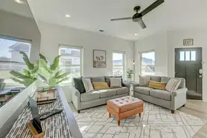 Living room with ceiling fan and light hardwood / wood-style floors