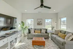 Living room featuring light hardwood / wood-style flooring, a wealth of natural light, and ceiling fan