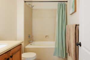 Full bathroom featuring vanity, shower / tub combo, and toilet