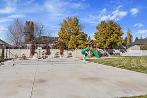 View of patio featuring tennis court and a playground