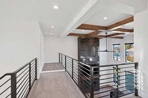 Stairway with carpet flooring and beam ceiling