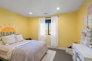 Bedroom with dark colored carpet