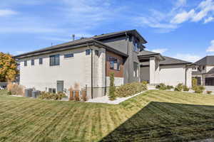 View of property exterior featuring central AC unit and a yard