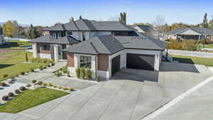 View of front facade with a front lawn and a garage