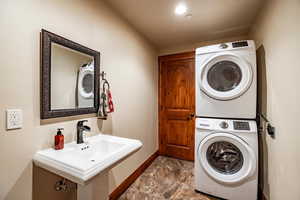 Clothes washing area with stacked washer and dryer