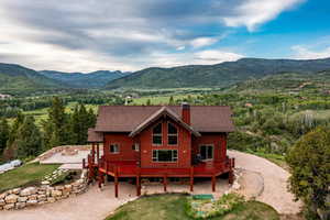 Back of property with a deck with mountain view