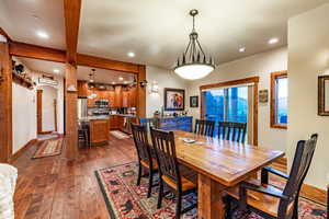 Dining space featuring beam ceiling and dark hardwood / wood-style flooring