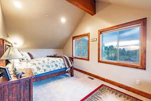 Bedroom with carpet and lofted ceiling with beams