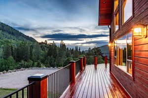 Deck at dusk featuring a mountain view