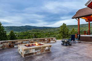 View of patio featuring a mountain view and a fire pit