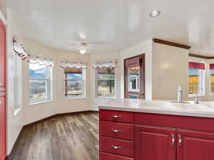 Kitchen featuring ornamental molding, a textured ceiling, ceiling fan, sink, and light hardwood / wood-style floors