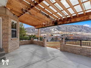 View of patio with a mountain view and a pergola