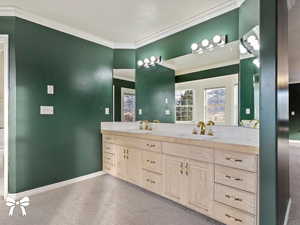 Bathroom with vanity and crown molding