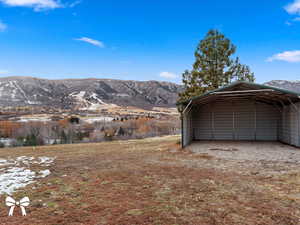 Garage featuring a carport and a mountain view