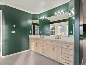 Bathroom with vanity and crown molding