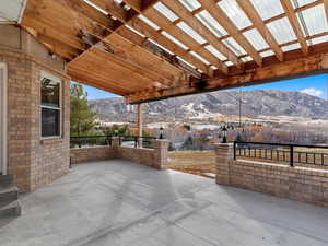 View of patio with a mountain view and a pergola