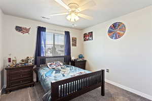 Carpeted bedroom with ceiling fan