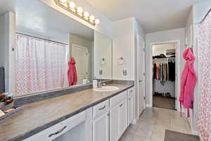 Bathroom featuring tile patterned floors and vanity