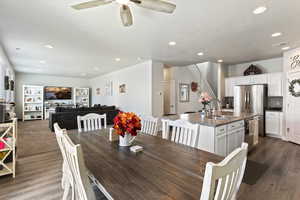 Dining space with ceiling fan, sink, a textured ceiling, and hardwood / wood-style flooring