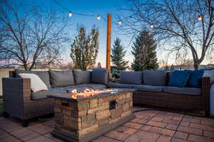 Patio terrace at dusk featuring an outdoor living space